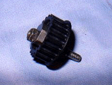 944 Turbo timing belt tensioner roller after stud shear, showing the nut from the oil pump retaining stud on the reverse side